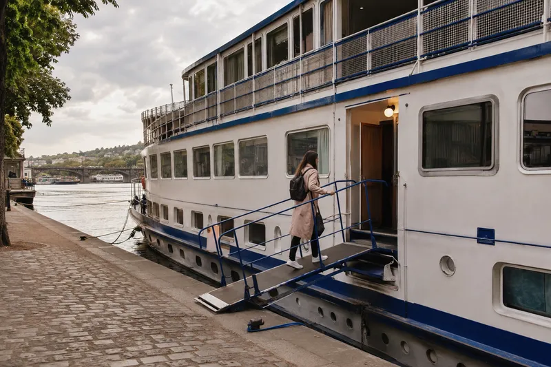 Converted riverboat hotel moored along a city riverbank